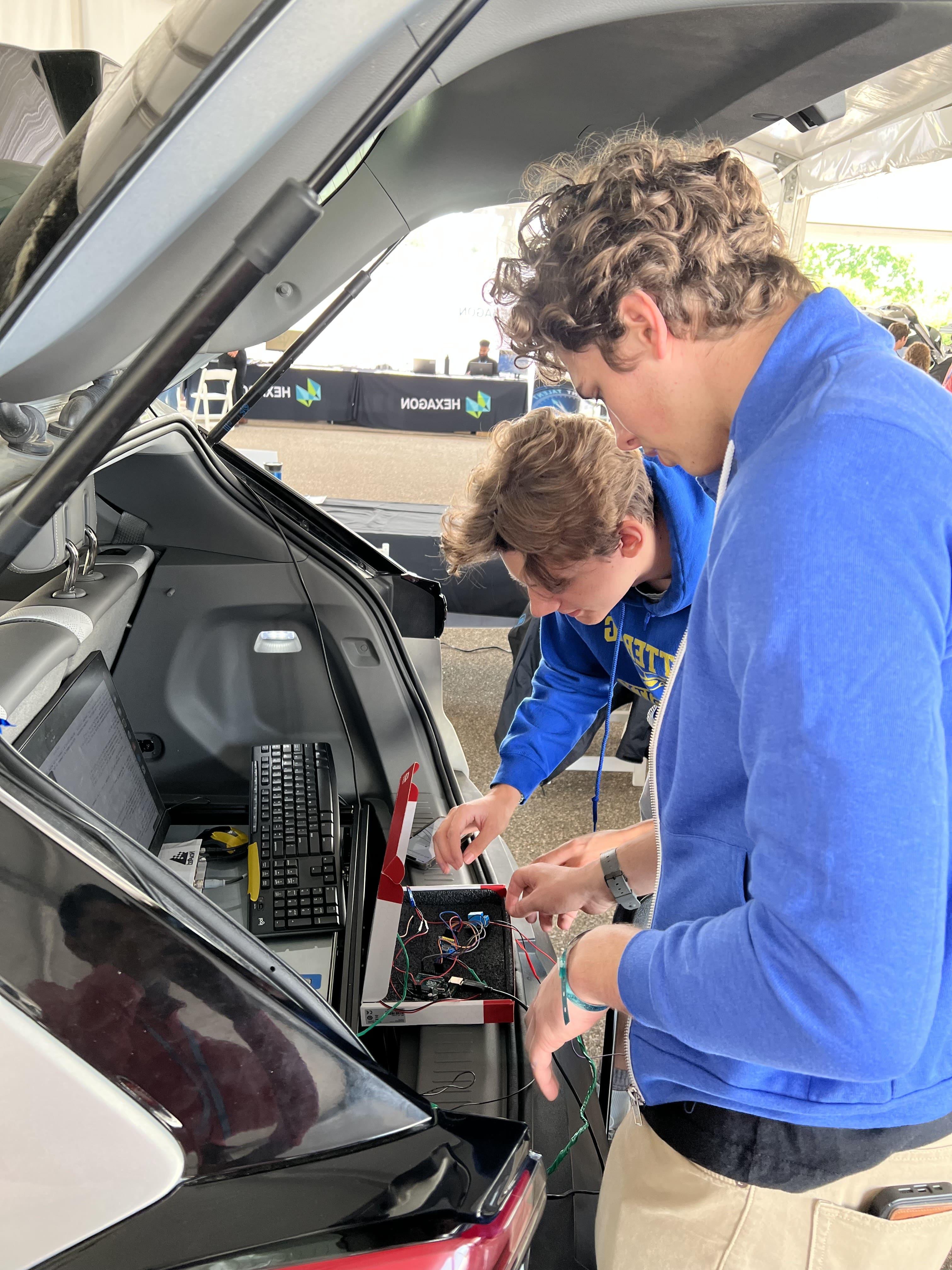 Kettering University students work on their car at the AutoDrive II Challenge